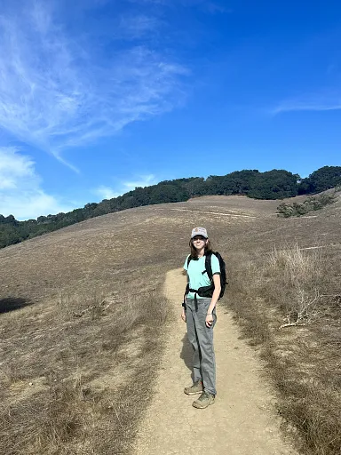 Ella Murphy on a trail in the golden California hills